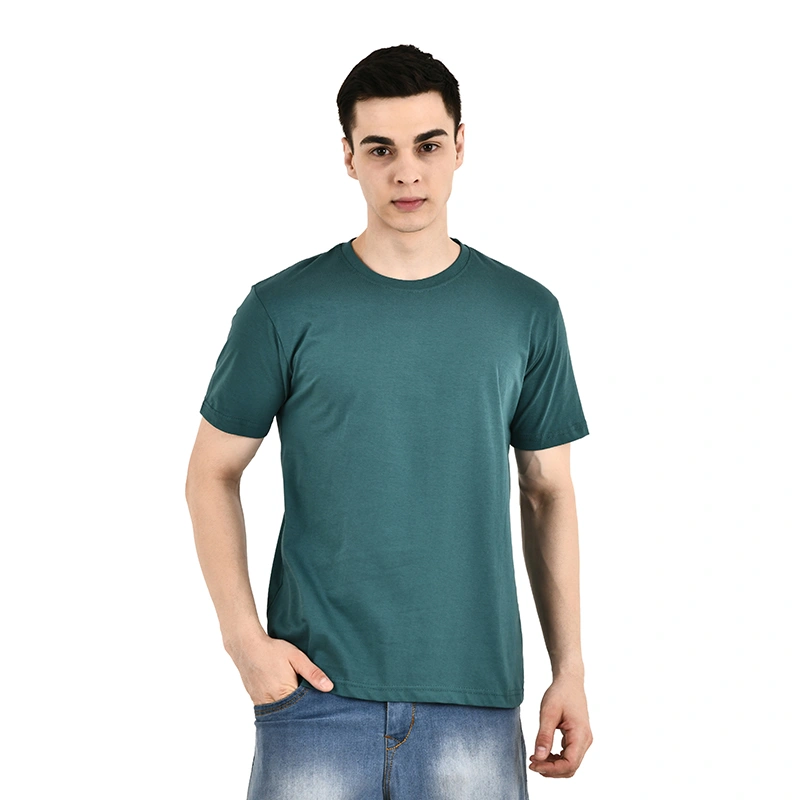 Male model in solid teal green round-neck t-shirt with blue denim jeans - menswear ecommerce photography by Lohar Studio Delhi